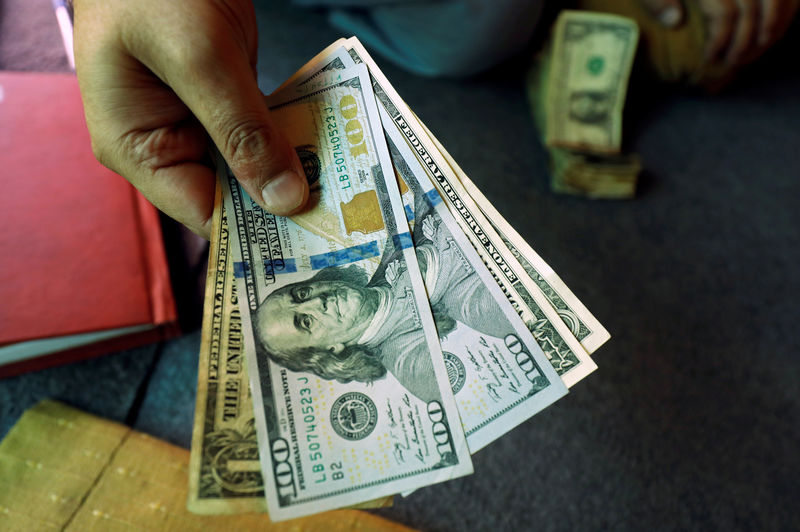 Dollar edges lower as safe haven premium dissipates