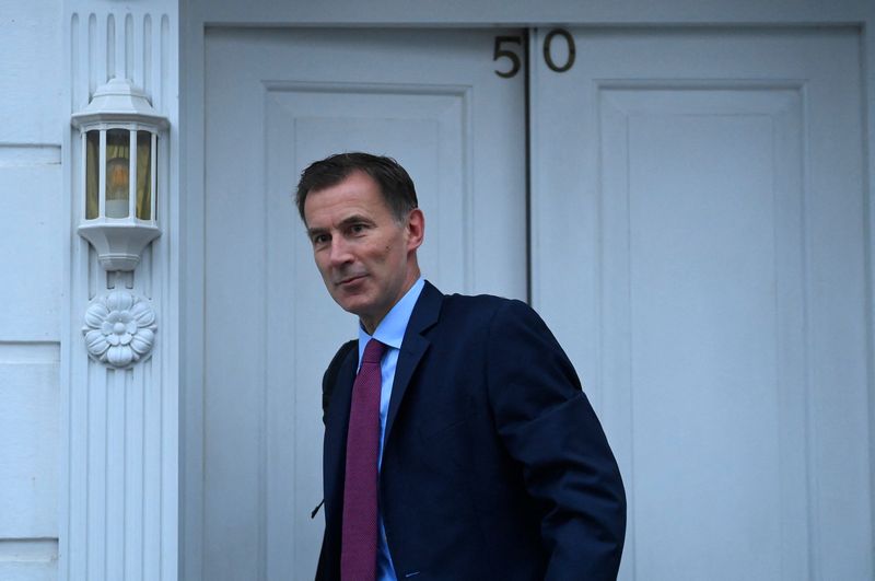 UK's Hunt hikes taxes, tightens grip on spending in tough budget