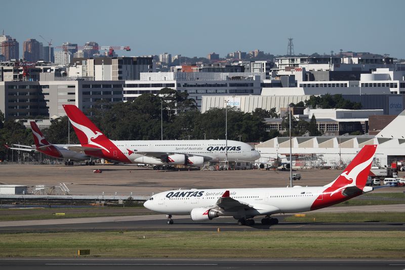 Qantas lifts first-half profit view, mulls shareholder returns next year