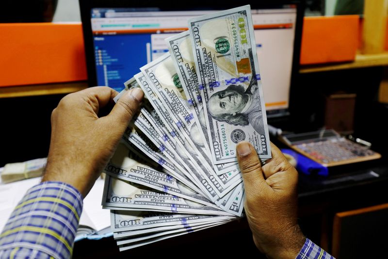 Dollar higher but still set for biggest weekly loss since May