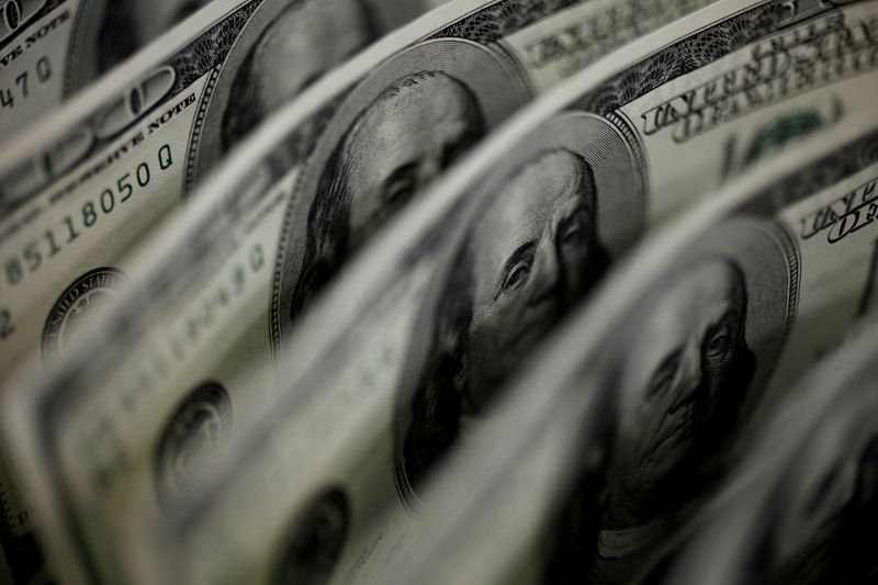 Dollar trades near one-year high ahead of Fed meeting minutes
